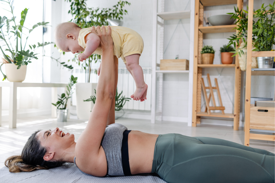 Adult supporting a young child during movement and play